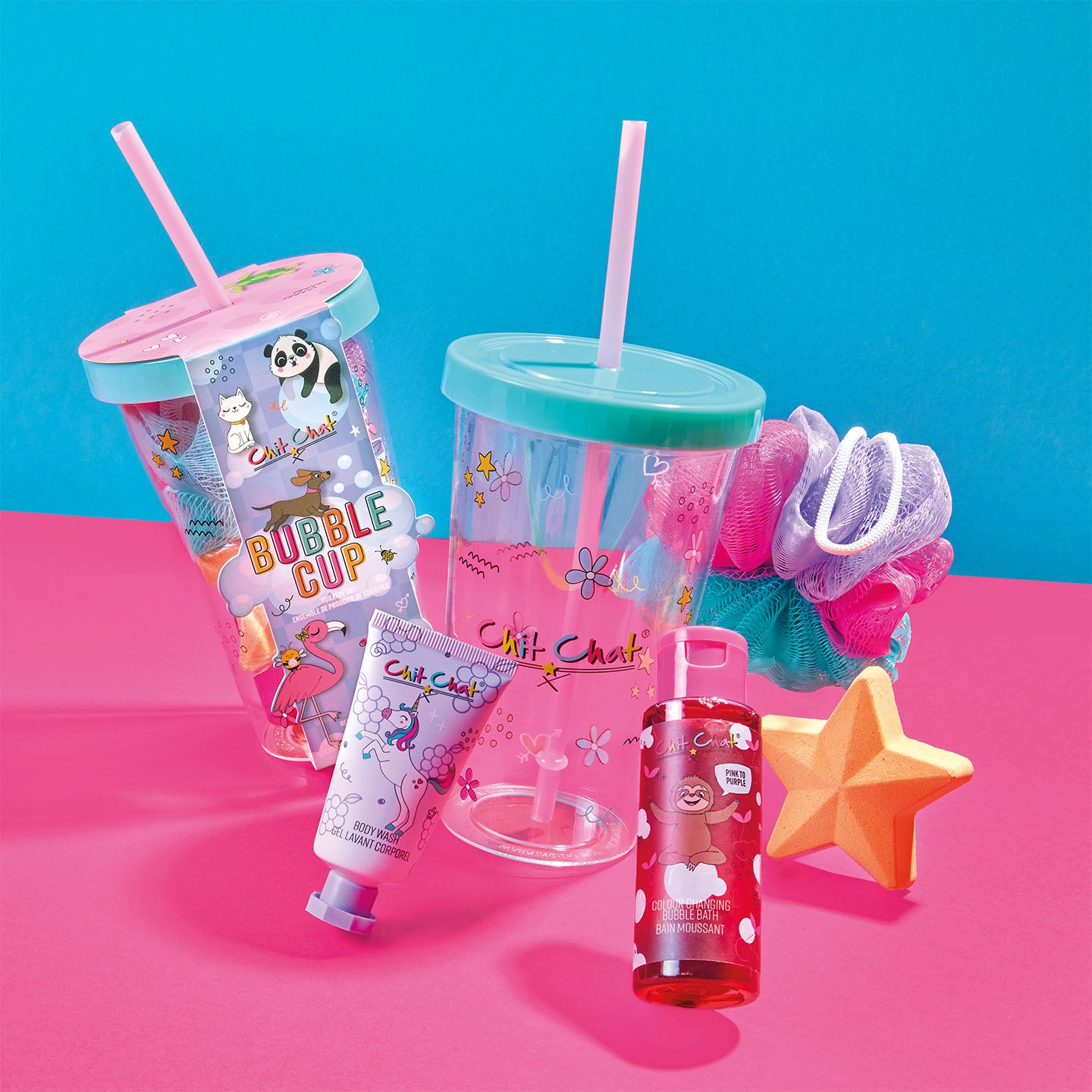 Children's bubble cup, bath bomb, and other items on a pink and blue background